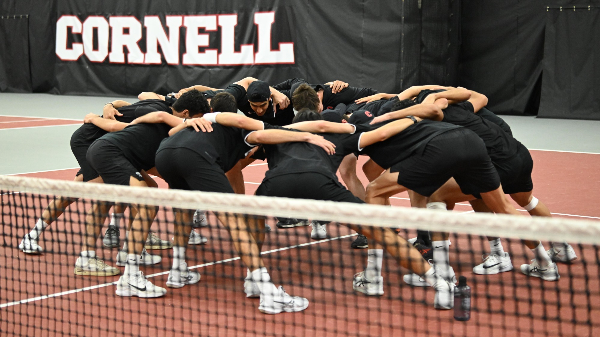 The Cornell men's tennis team huddles together prior to its 5-2 victory over #30 Princeton on Friday, April 11, 2025 at the Reis Tennis Center in Ithaca, N.Y.