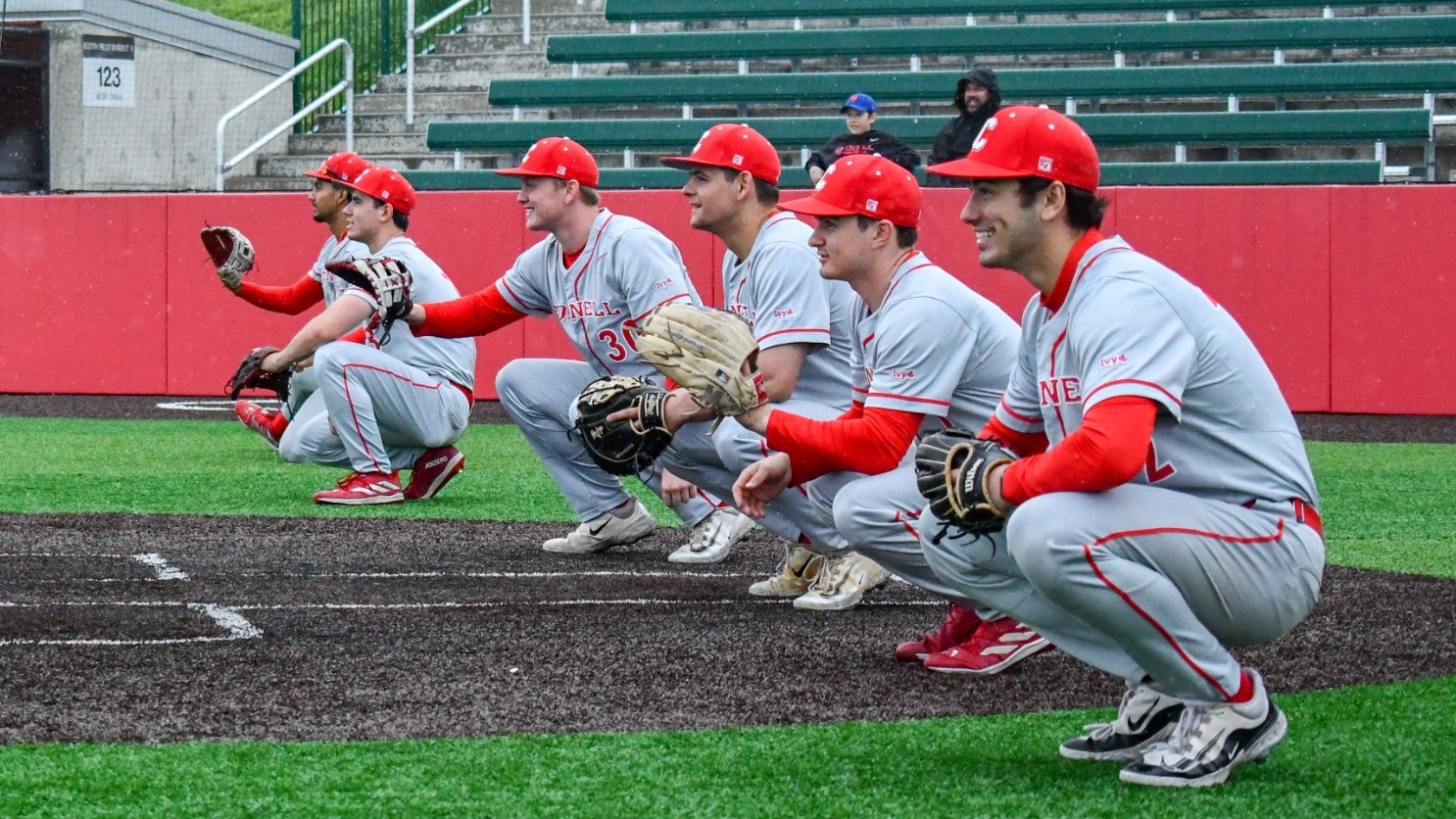 Members of the Cornell baseball Class of 2025 crouch to catch a baseball from a parent prior to its game against Princeton at Booth Field in Ithaca, N.Y., on May 4, 2025.