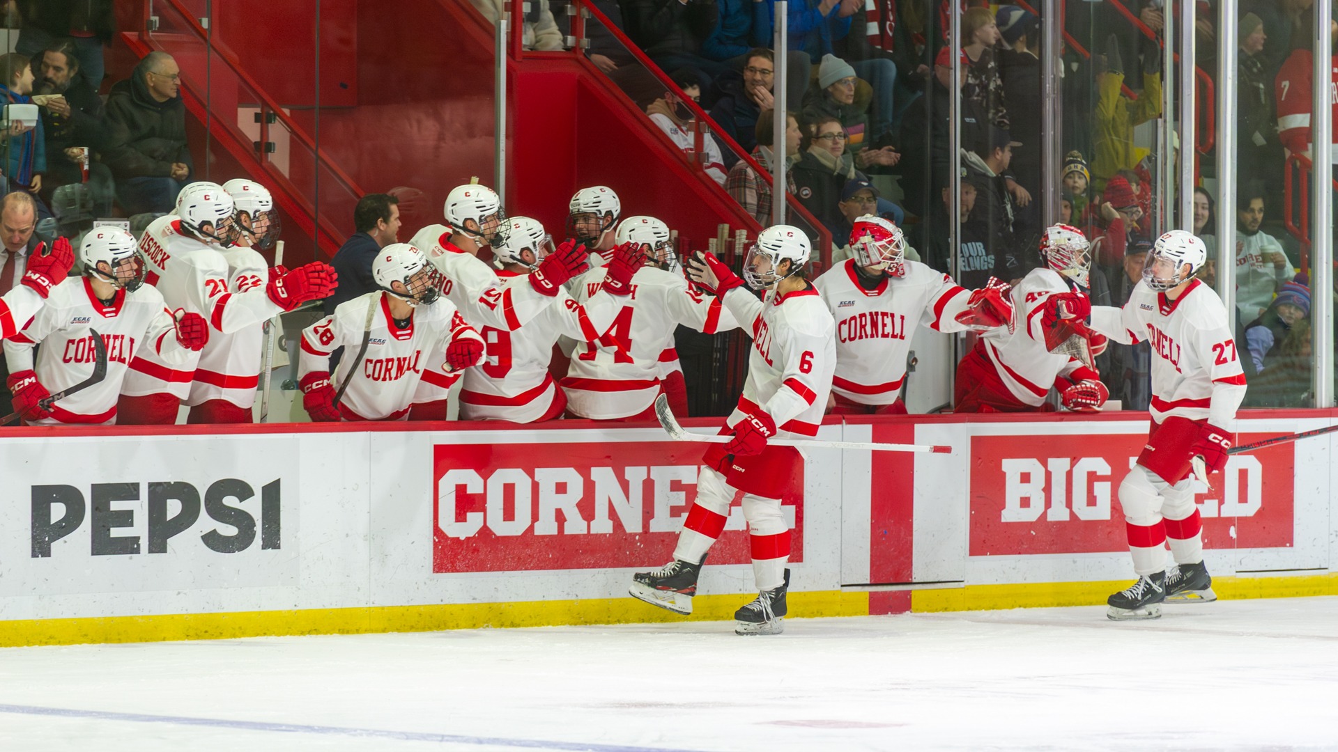 Cornell men's hockey junior defenseman George Fegaras high-fives teammates on the bench after scoring against Omaha at Lynah Rink in Ithaca, N.Y., on Jan. 2, 2025.