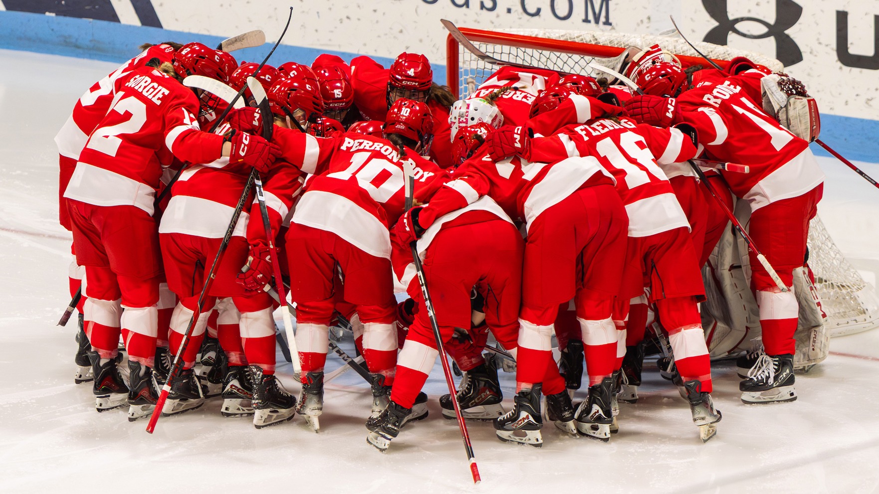 Cornell women's ice hockey huddles at Ingalls Rink.