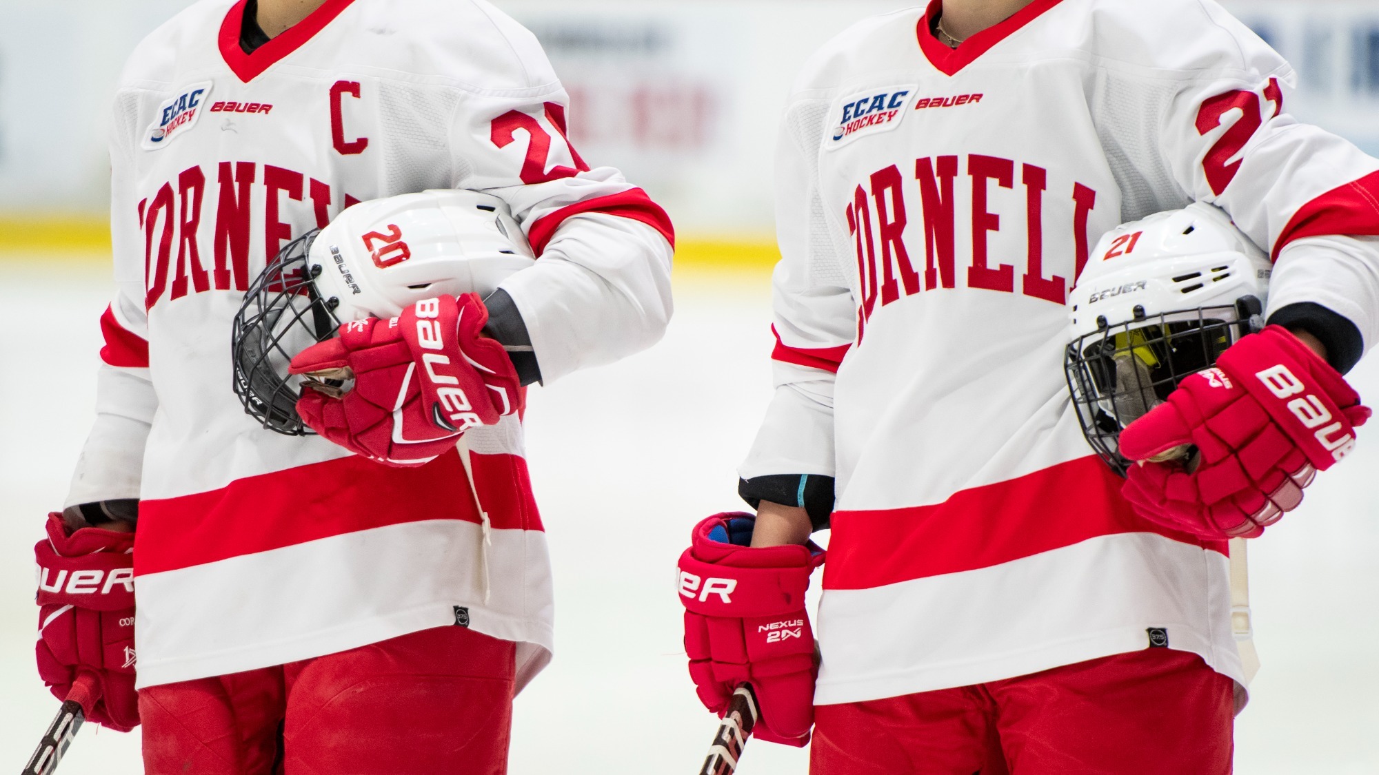 O'Neill, Curlew stand on the blue line for the national anthem at Lynah Rink.