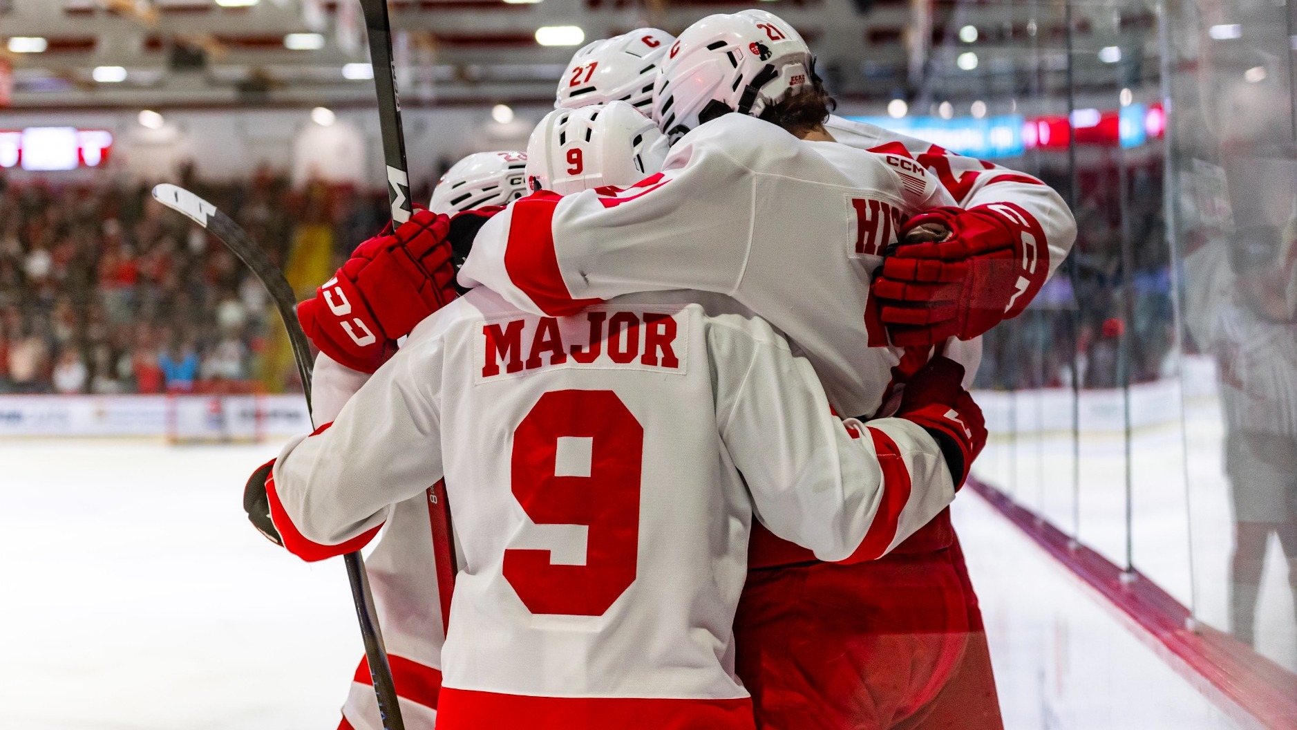 Members of the Cornell men's hockey team celebrate after scoring against Harvard on March 15, 2026, at Lynah Rink in Ithaca, N.Y.