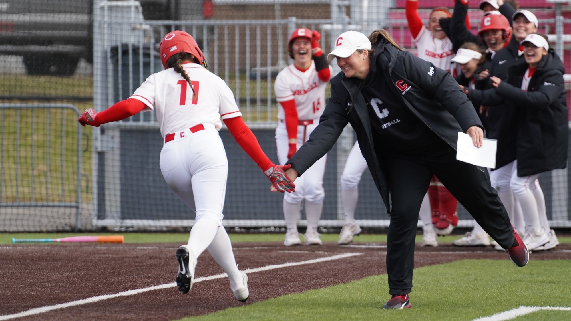 Lopez celebrates with coach and teammates as she approaches home plate at Niemand-Robison Field.