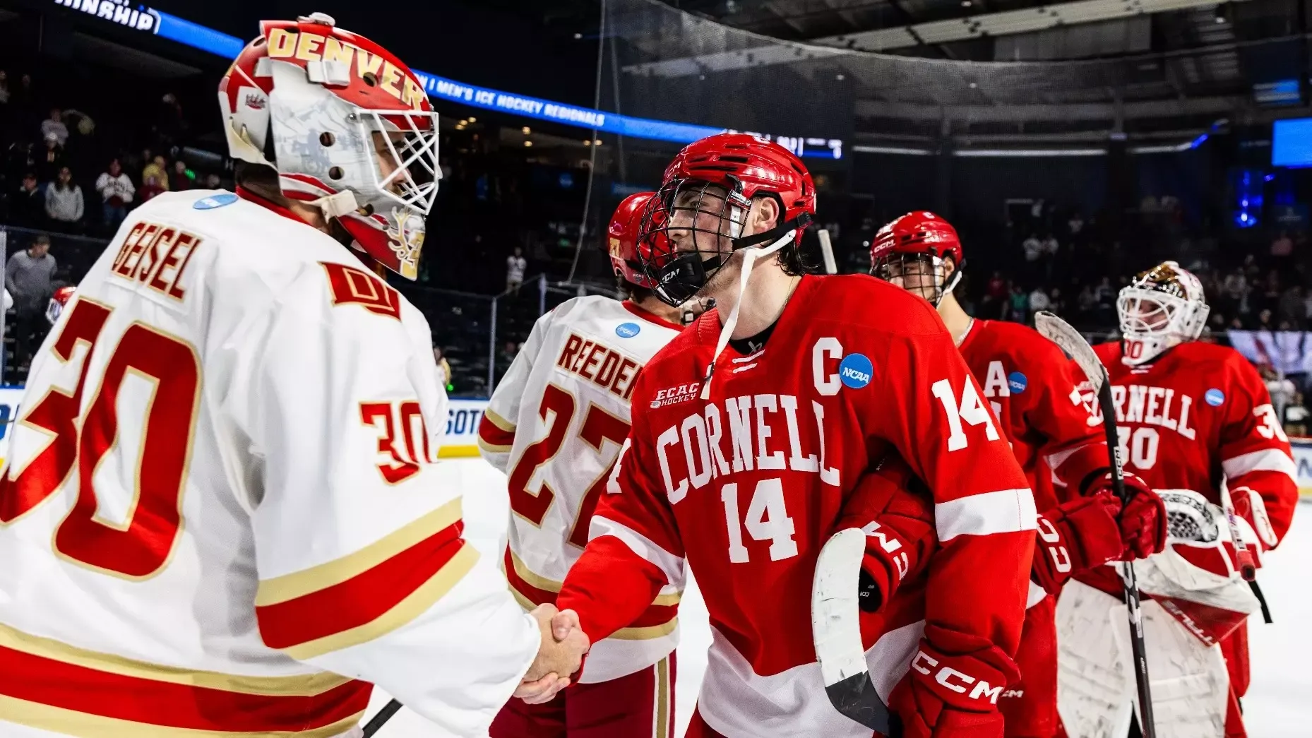 Cornell men's hockey junior forward Ryan Walsh shakes hands with Denver goaltender Peyton Geisel after the Pioneers' 5-0 win over the Big Red at Blue Arena in Loveland, Colo., on March 27, 2026.