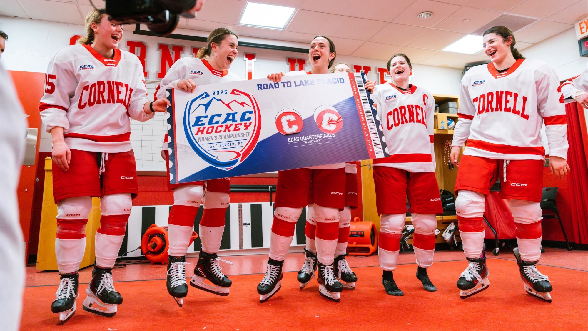 Women's ice hockey celebrates with a ticket punched poster in the locker room at Lynah Rink.