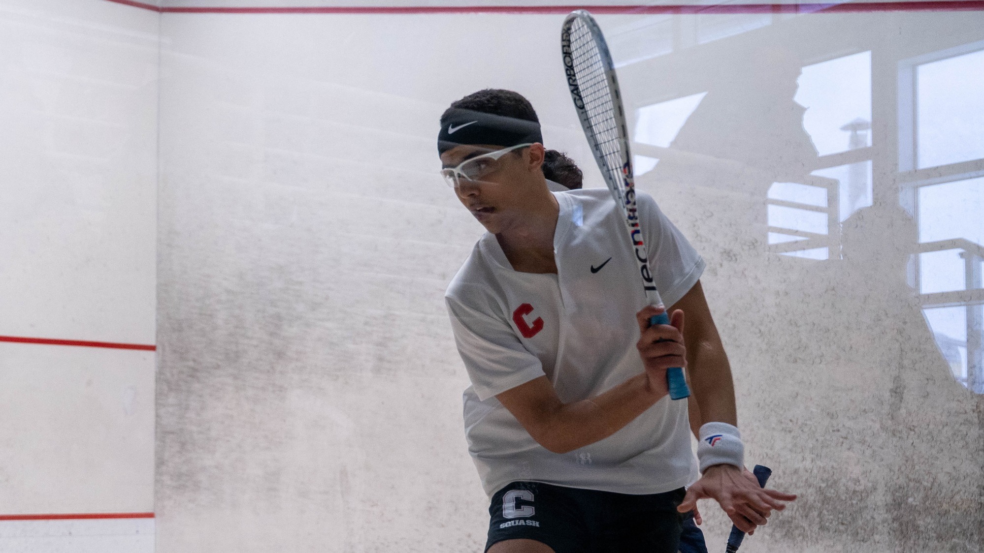Cornell freshman men's squash player Aly Ezzat goes to hit a squash ball during match action against Yale on Feb. 14, 2026, at the Belkin Squash Courts in Ithaca, N.Y.