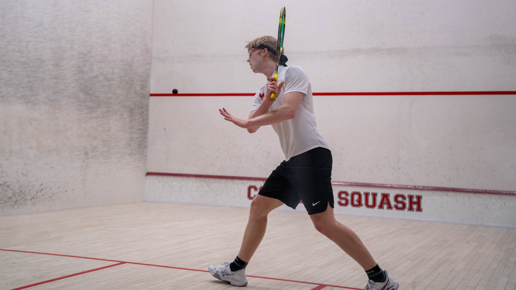 Cornell sophomore men's squash player Roman Bicknell goes to serve a squash ball during match action against Yale on Feb. 14, 2026, at the Belkin Squash Courts in Ithaca, N.Y.