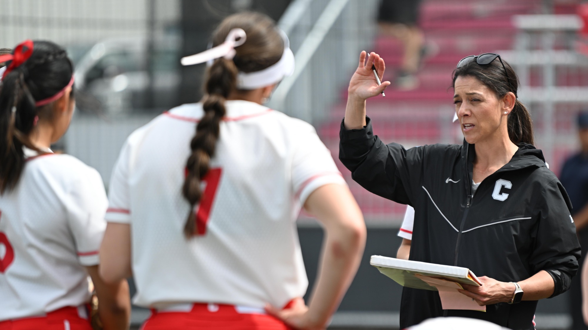 Tara Smith holds a conversation with Wolfe, Cai at Niemand-Robison Field.