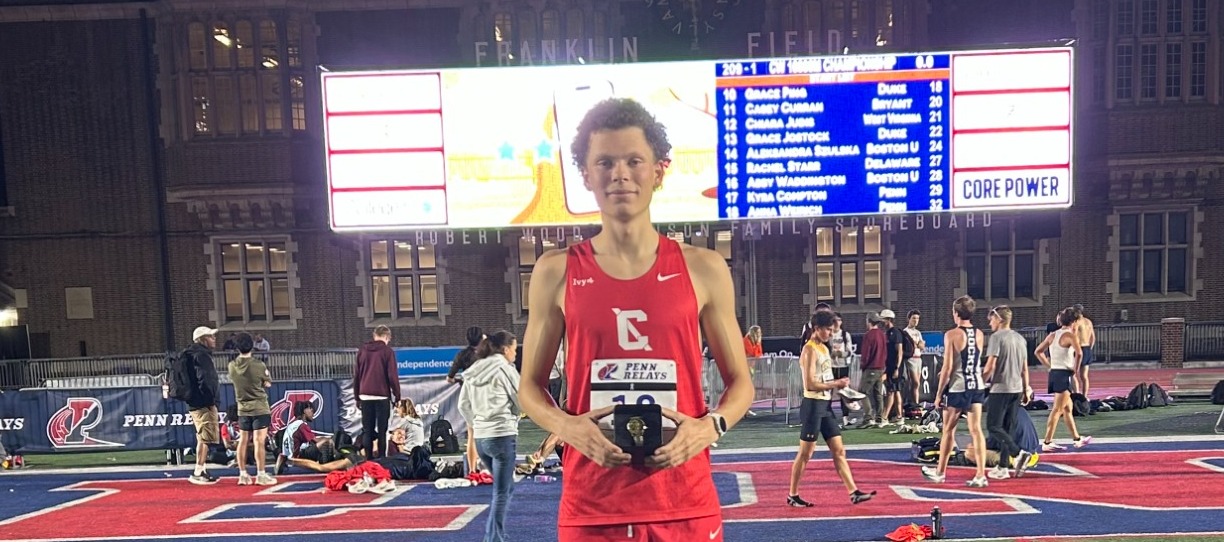 Pierre Attigobe on the podium after winning 5000m race at Penn Relays 2026