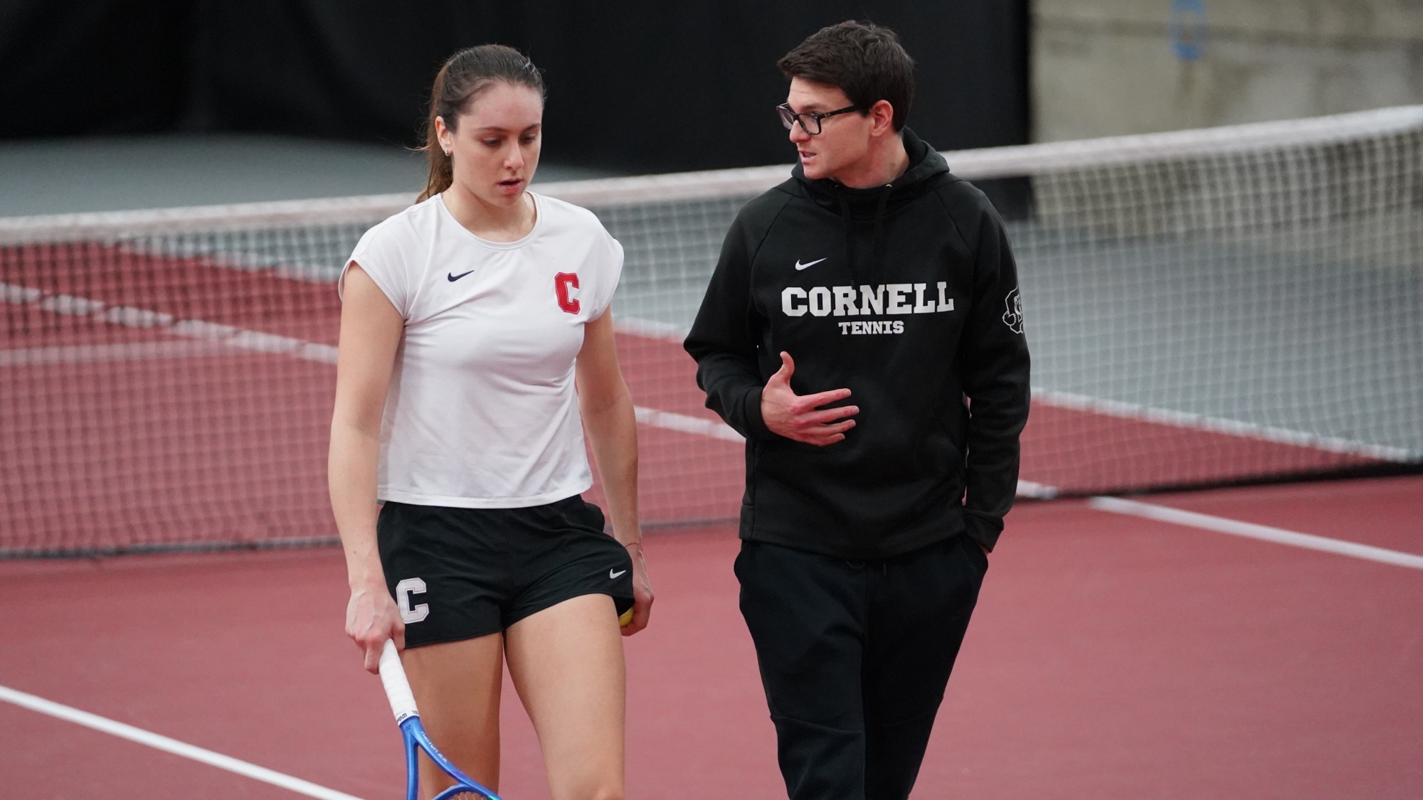 Michelle Ryndin and interim head coach Spencer Furman chat between points during Cornell's match with Yale on Saturday, April 4, 2026 at Reis Tennis Center in Ithaca, N.Y.