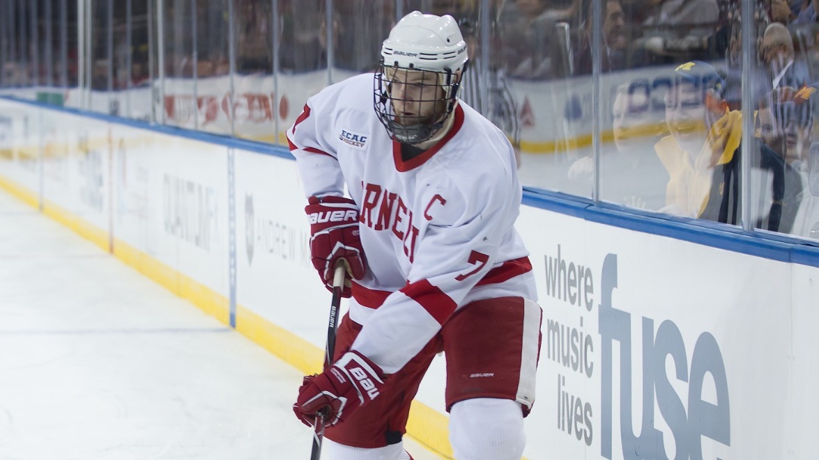 Former Cornell men's hockey defenseman Braden Birch '13 controls the puck during game action against Michigan at Madison Square Garden during the biennial Frozen Apple game in New York City during the 2012-13 season.