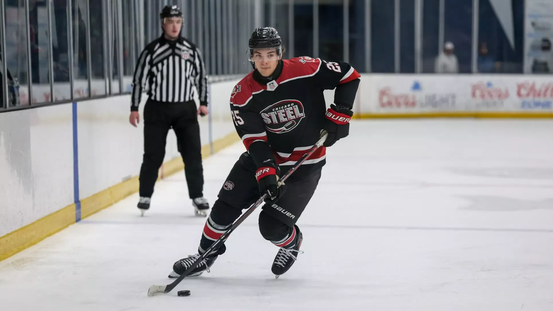 An action photo of incoming Cornell men's hockey freshman defenseman Cole Tuminaro skating during game action with the USHL's Chicago Steel during the 2025-26 season.