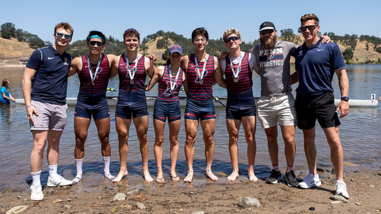 George Drago poses with members of Penn's crew following a race during the 2025-26 season.