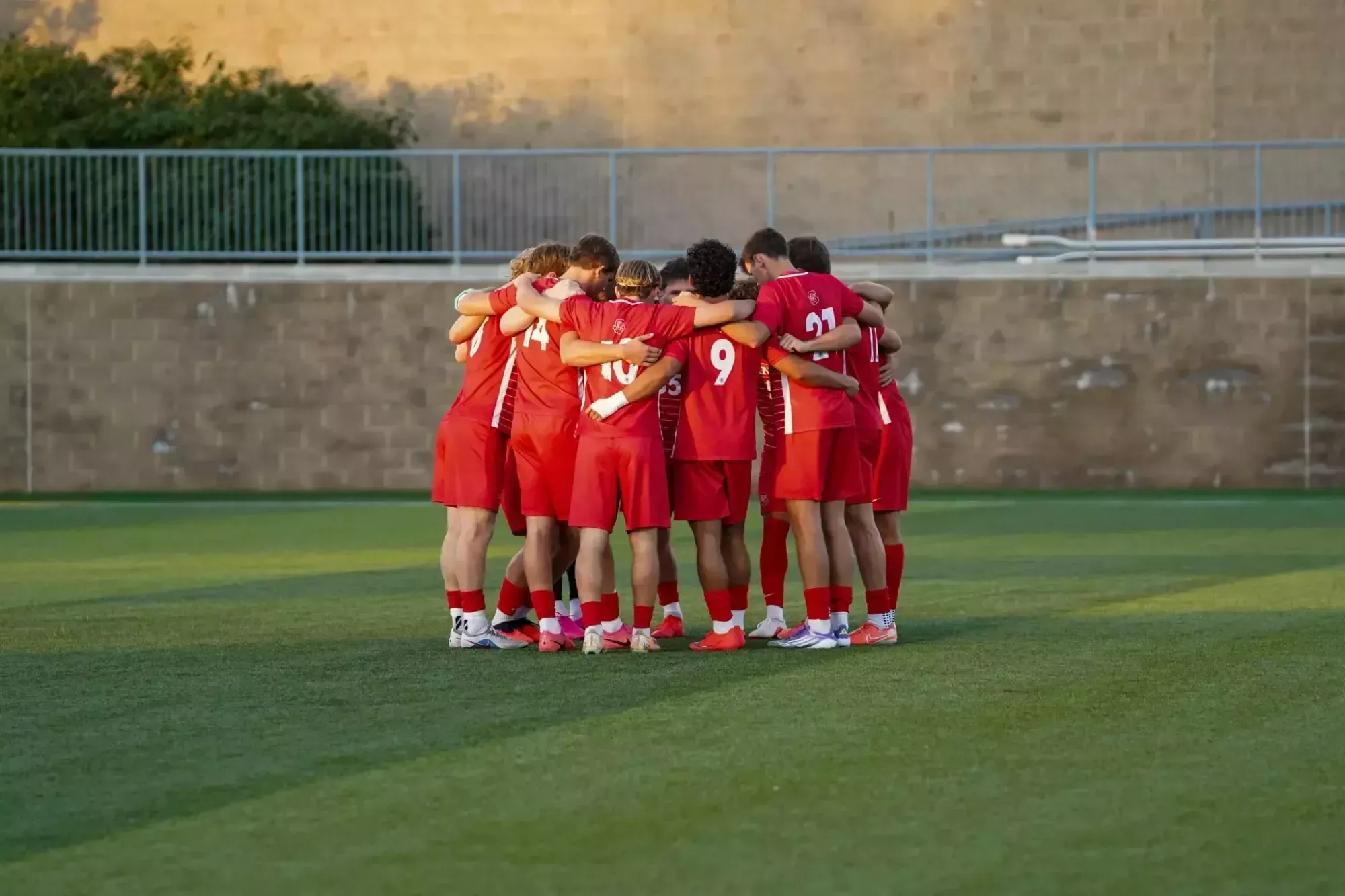 Men's Soccer in a huddle on the field before kick off at University of Pittsburgh