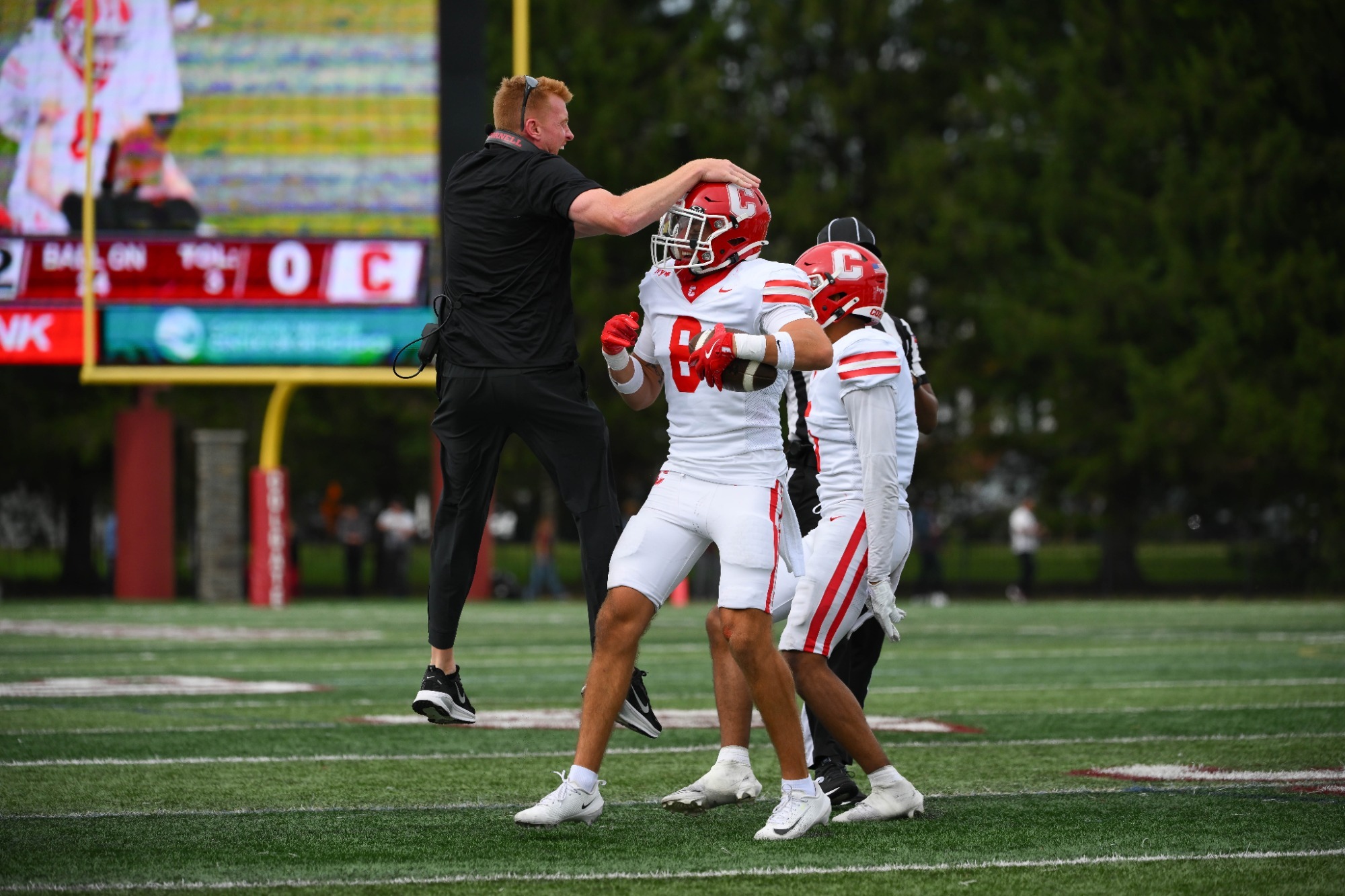 Tommmy MacPherson and Defensive Coordinator Mike Toerper celebrate an interception during Cornell football's week 1 loss to Colgate on Sept. 19, 2026 in Hamilton, N.Y.