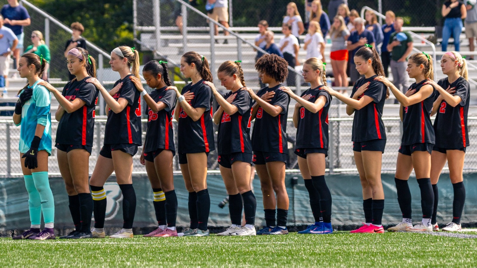 Members of the Cornell women's soccer team stand during the national anthem before a match against Binghamton on Sept. 13, 2026, at Bearcats Sports Complex in Vestal, N.Y.
