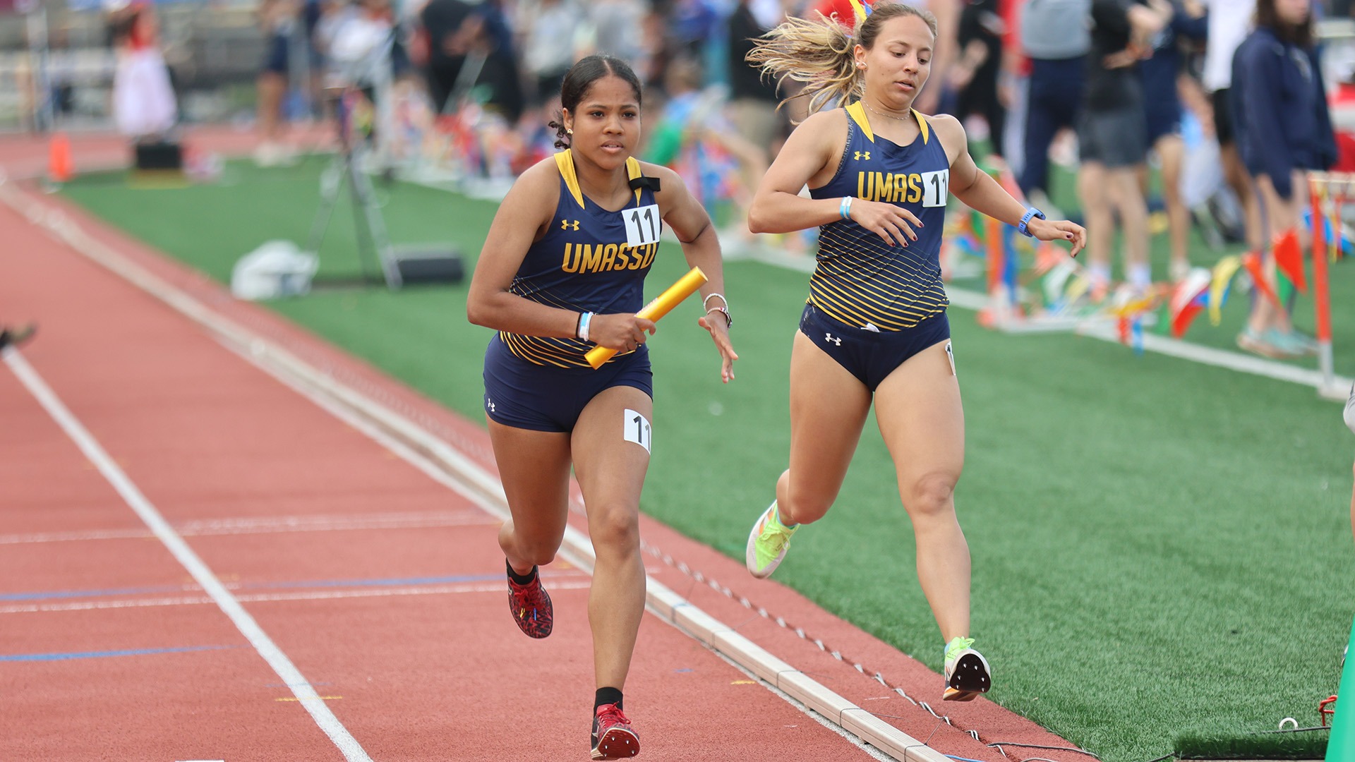Sara Lopez gets the baton from Julia Latura in the 4x800 meter relay