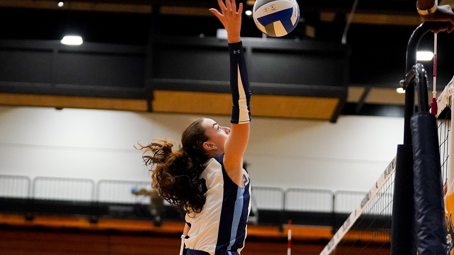 Maddie Carter goes up for an attack in a volleyball match