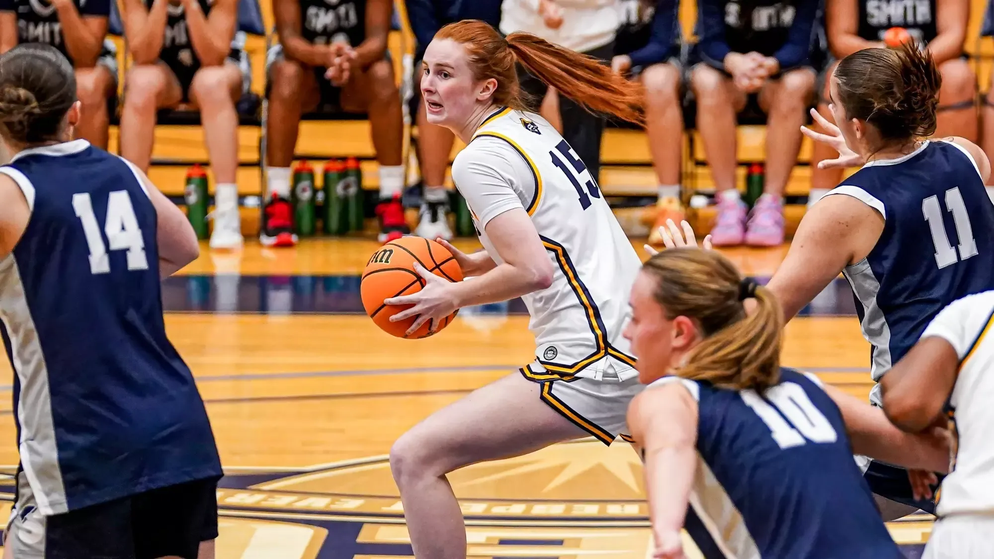 Action photo of Jillian Doherty playing in a women's basketball game 