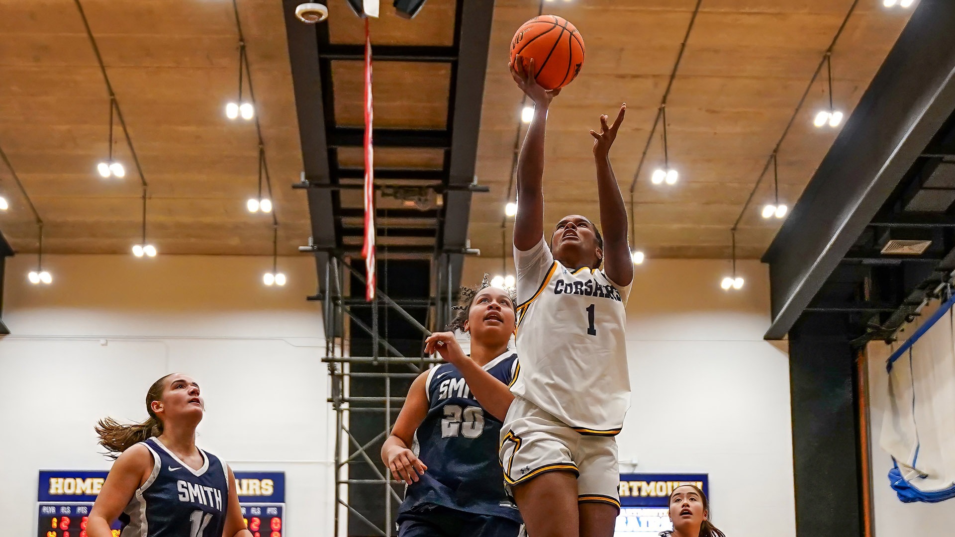 Yasmine Santos goes up for a shot in women's basketball