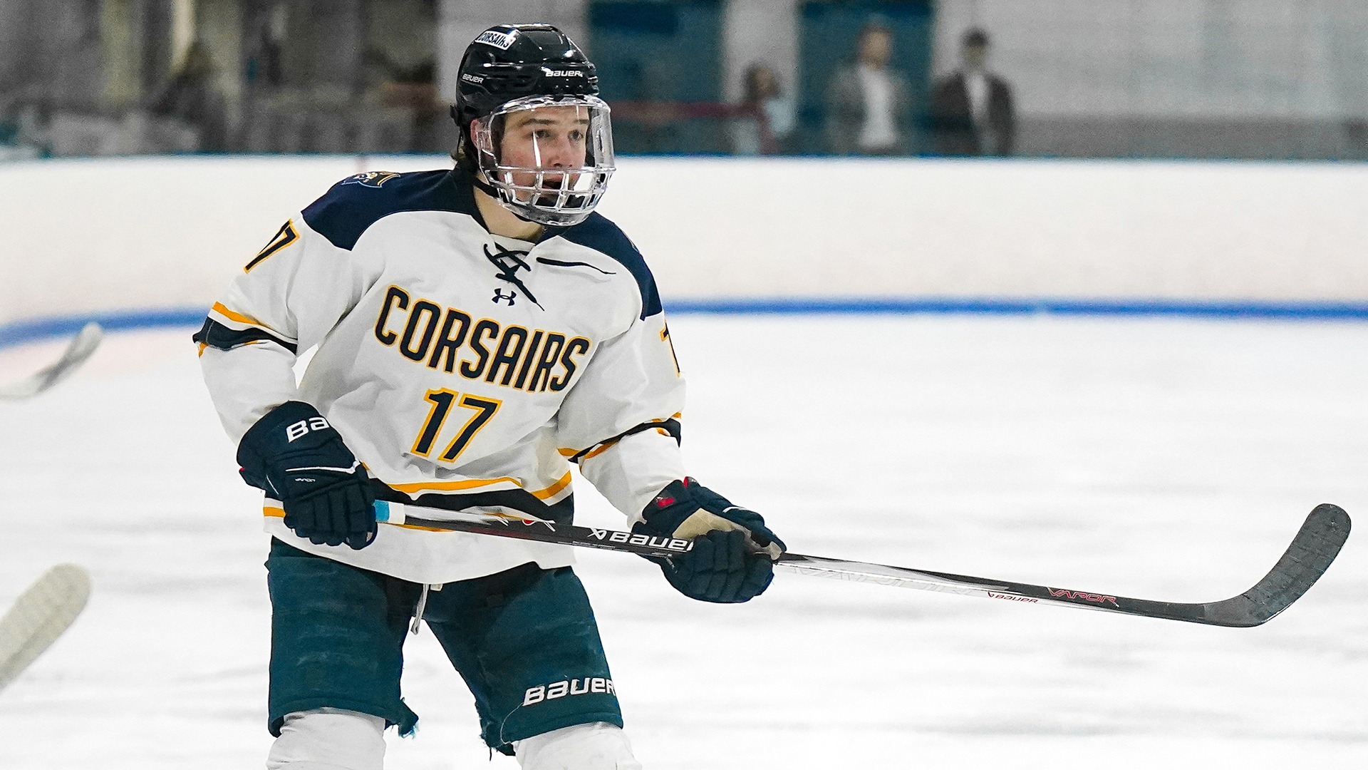 Levee Pakozdi passes the puck in a hockey game at Hetland Arena