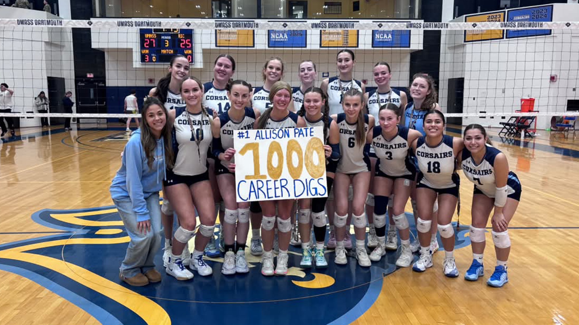 Senior Allison Pate celebrates with her team following her reaching the 1,000 career digs milestone against Rhode Island College