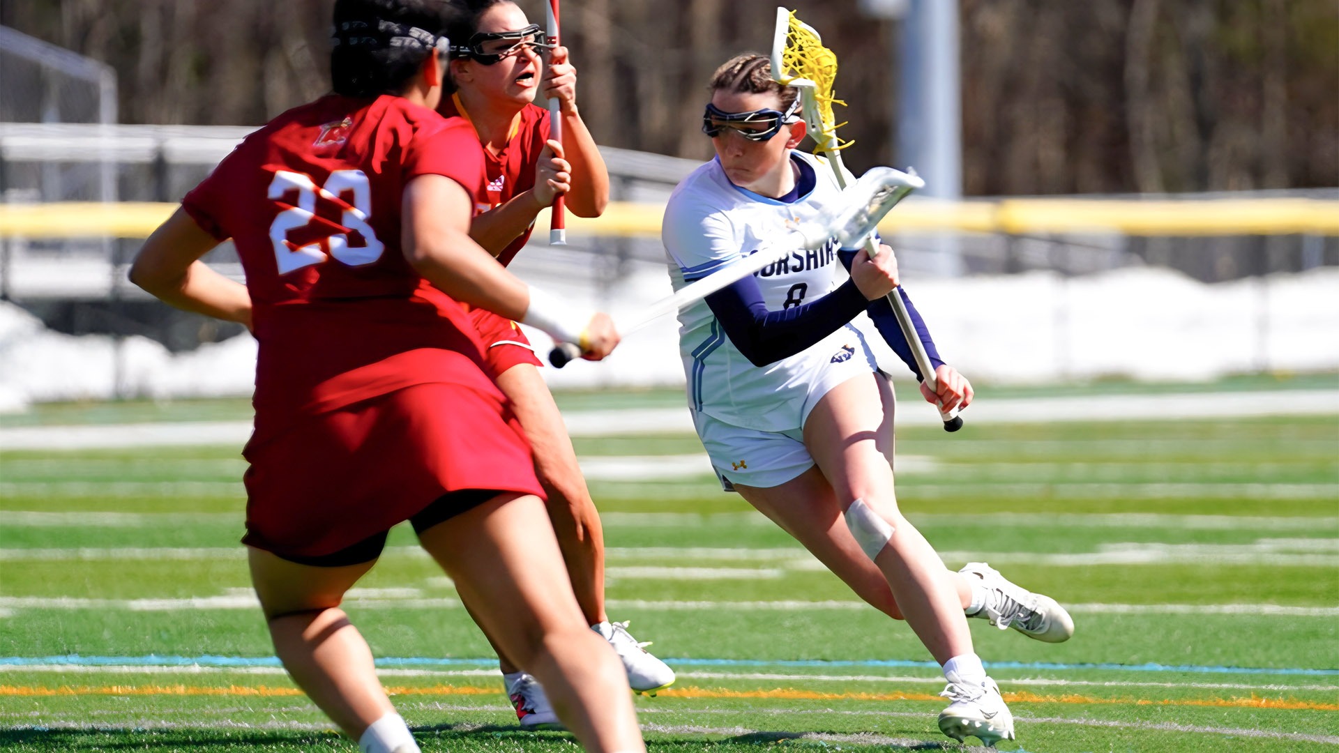 Maddy Allen powers toward the goal in a women's lacrosse game against Regis College - March 14, 2026