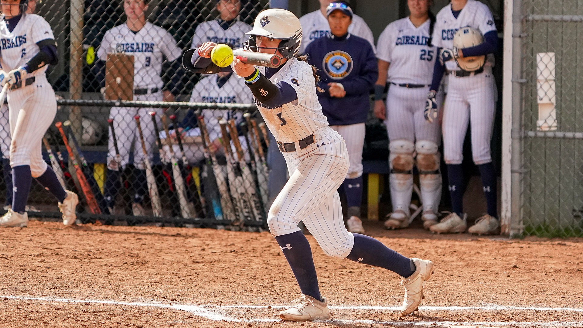 Emma Talpey lays down a bunt at bat during a softball game in 2025