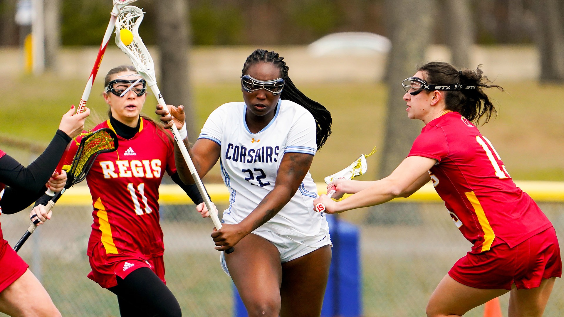 Myra Watkins-Rodriguez competes in a women's lacrosse game against Regis College