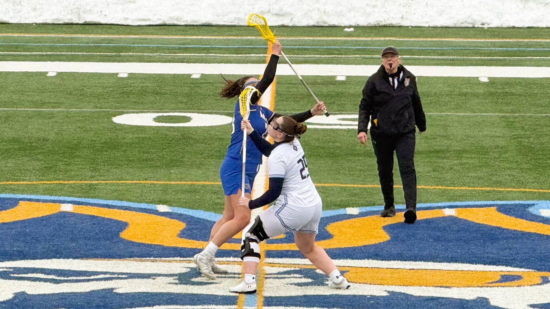 Women's Lacrosse captain Emma Terino takes a draw control against Maine Maritime