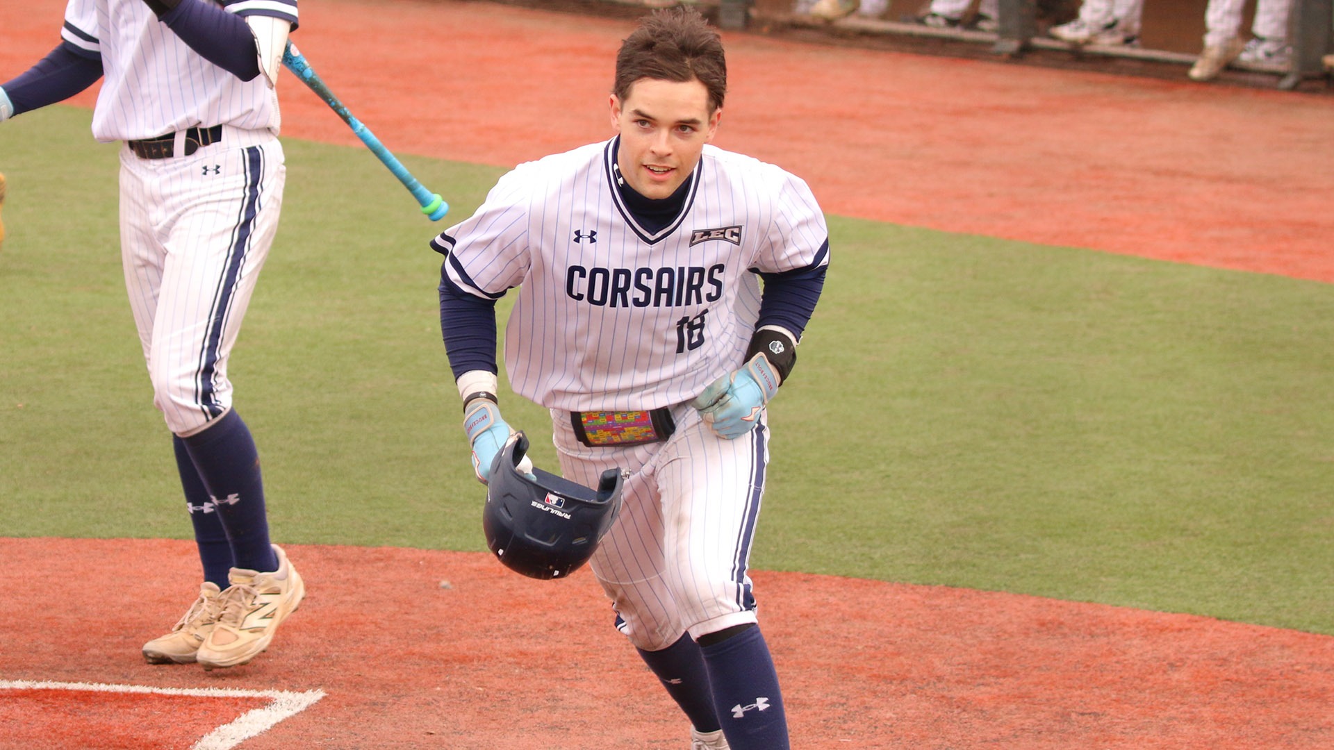 Sam Bradford crosses home plate after hitting a home run against SUNY Brockport - Baseball