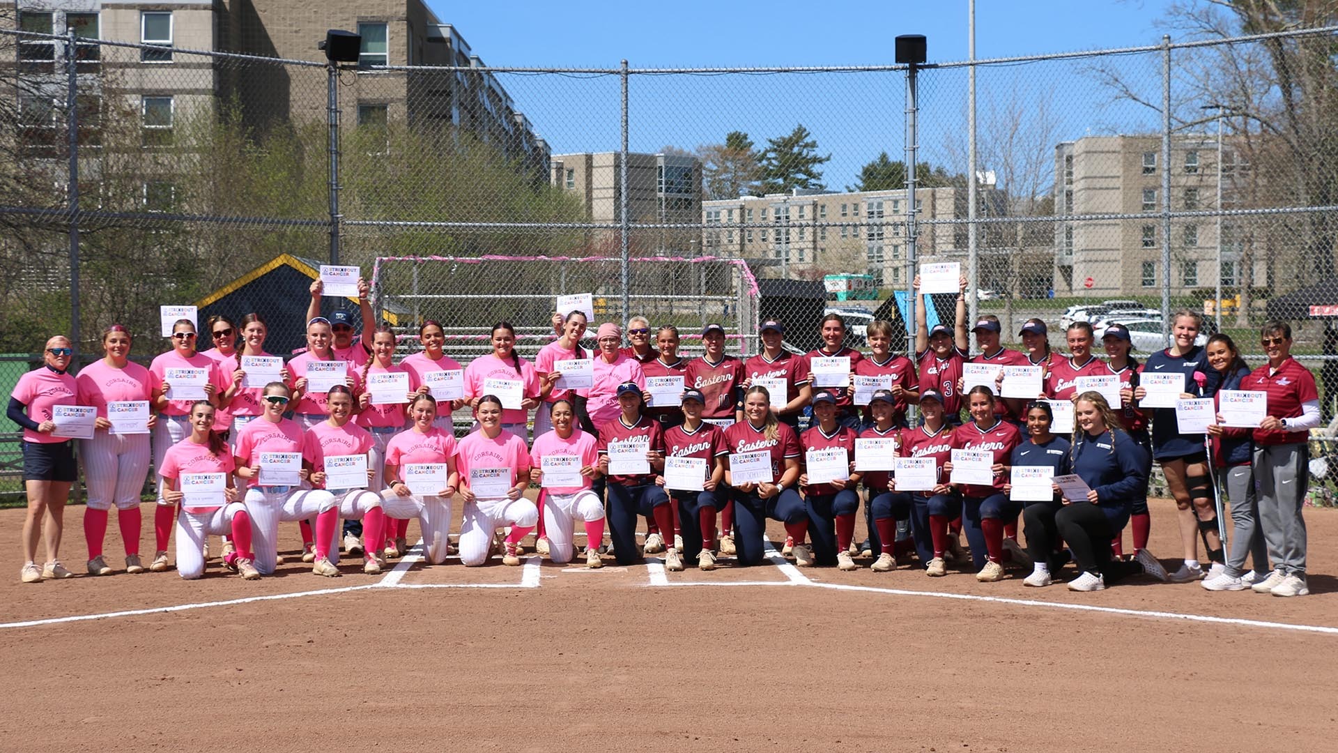 Group photo of UMass Dartmouth and Eastern Connecticut State in the NFCA Strikeout Cancer Pregame Event