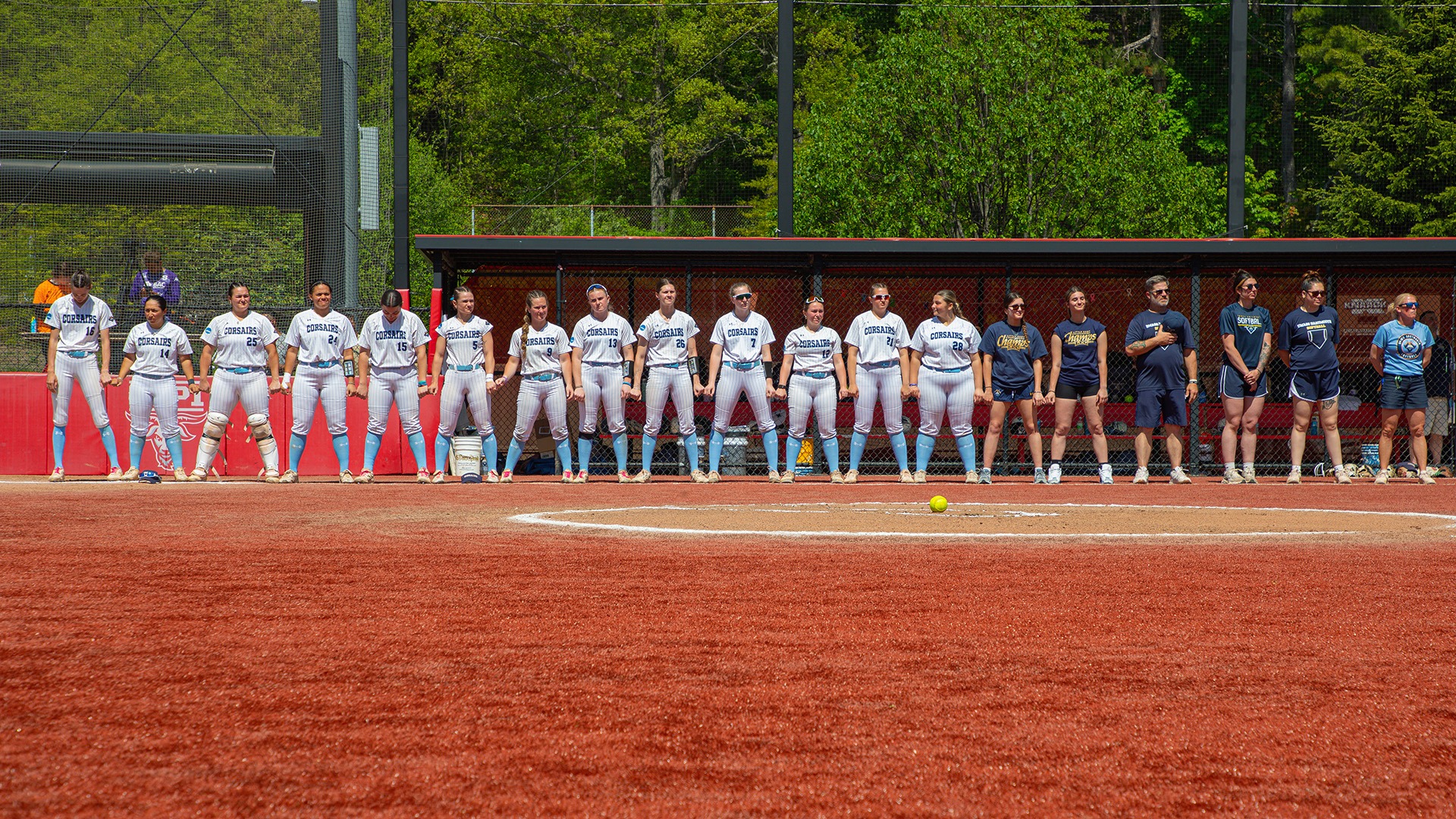 The UMass Dartmouth softball team stands together during introductions at the 2026 NCAA Regional Championships