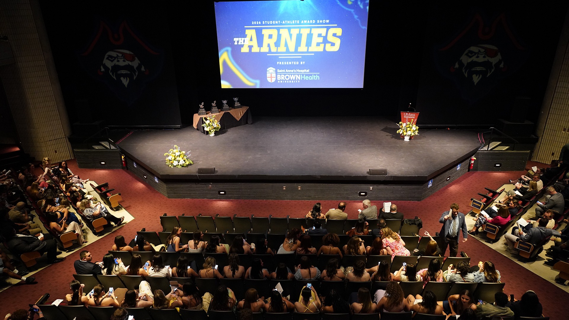 An overview image of the 2026 Arnies Award Show stage with student-athletes in the crowd