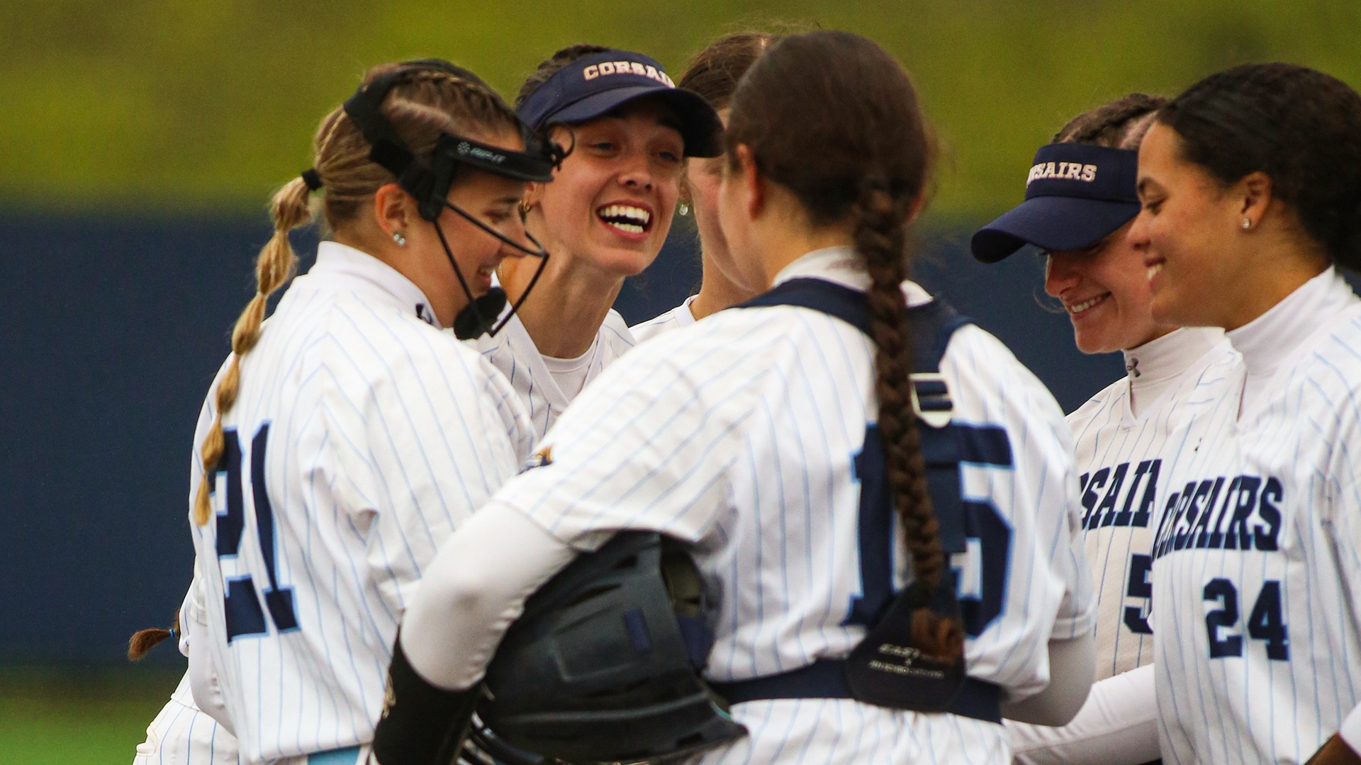 Corsairs softball players meet in the circle to celebrate a win over UMass Boston - May 9, 2026