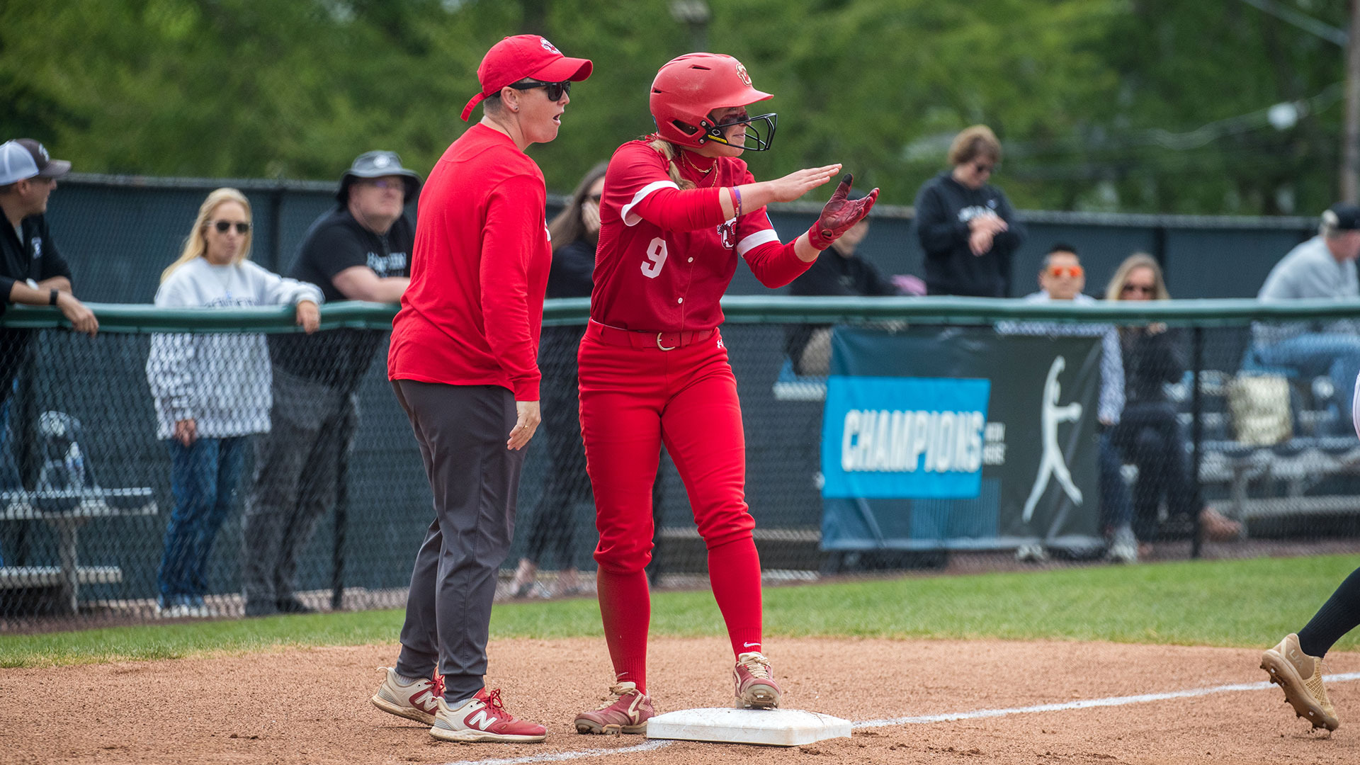 Photo of Softball Coach Molly O'Donnell and Maggie Cummings during an NCAA playoff game