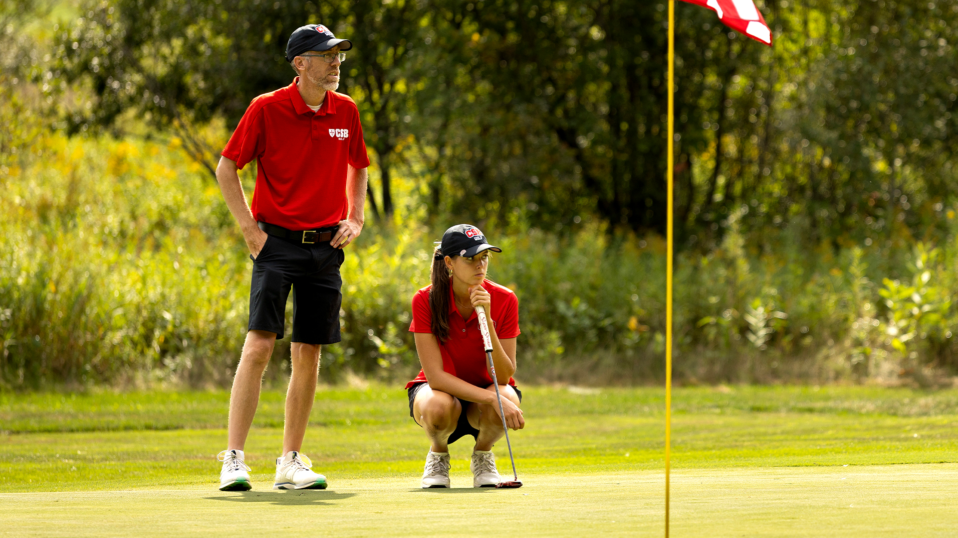 Hallie Johnson with Mark Krueger waiting to putt at CSB Fall Invite Sept. 6, 2026