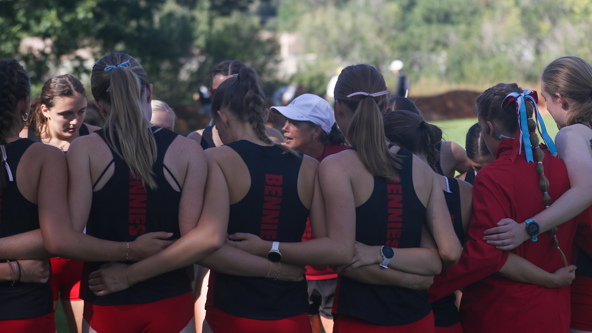 Cross country in a huddle at 2026 UCCS Rust Buster