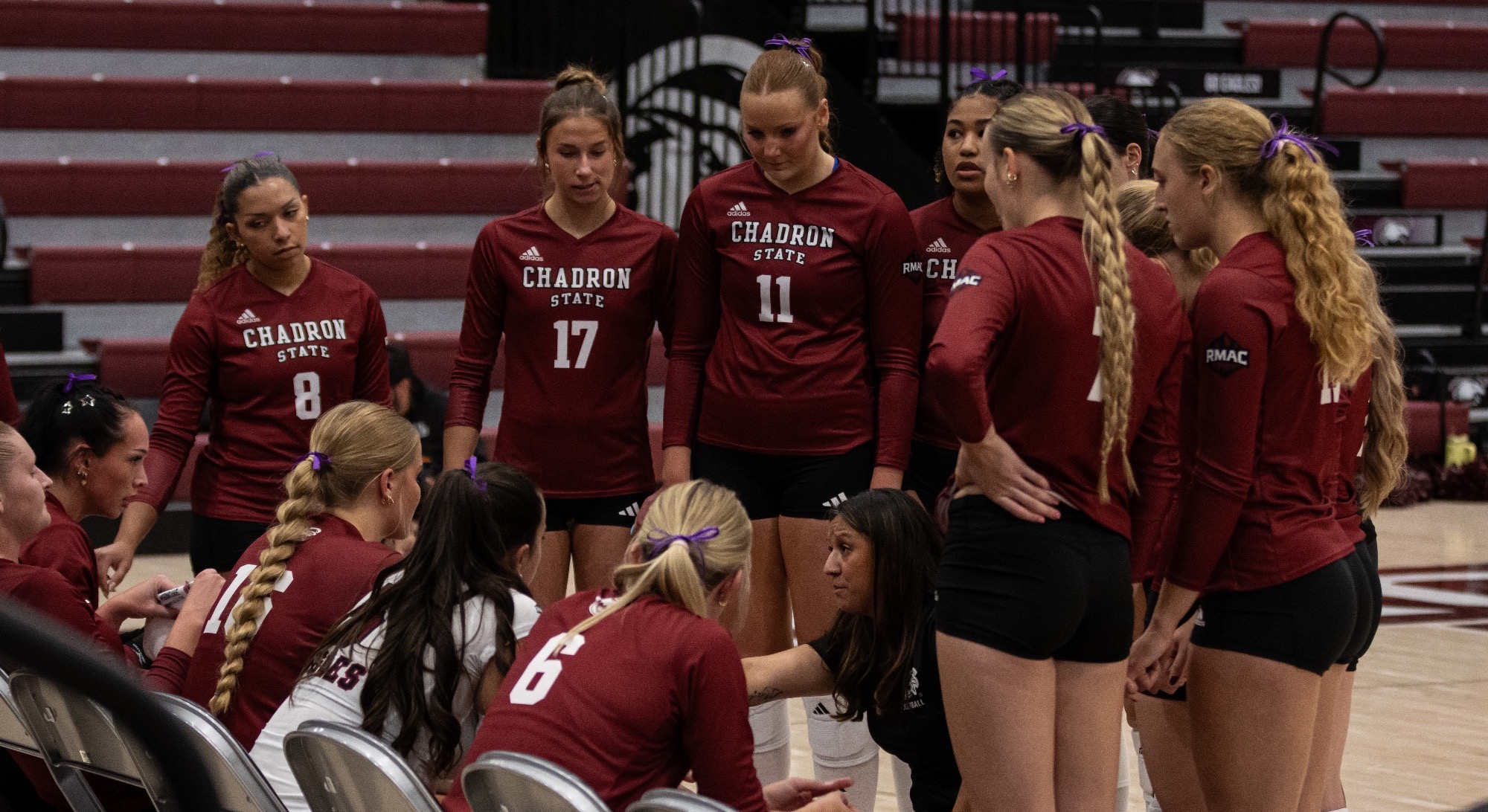Group sitting on the bench vs. NMHU