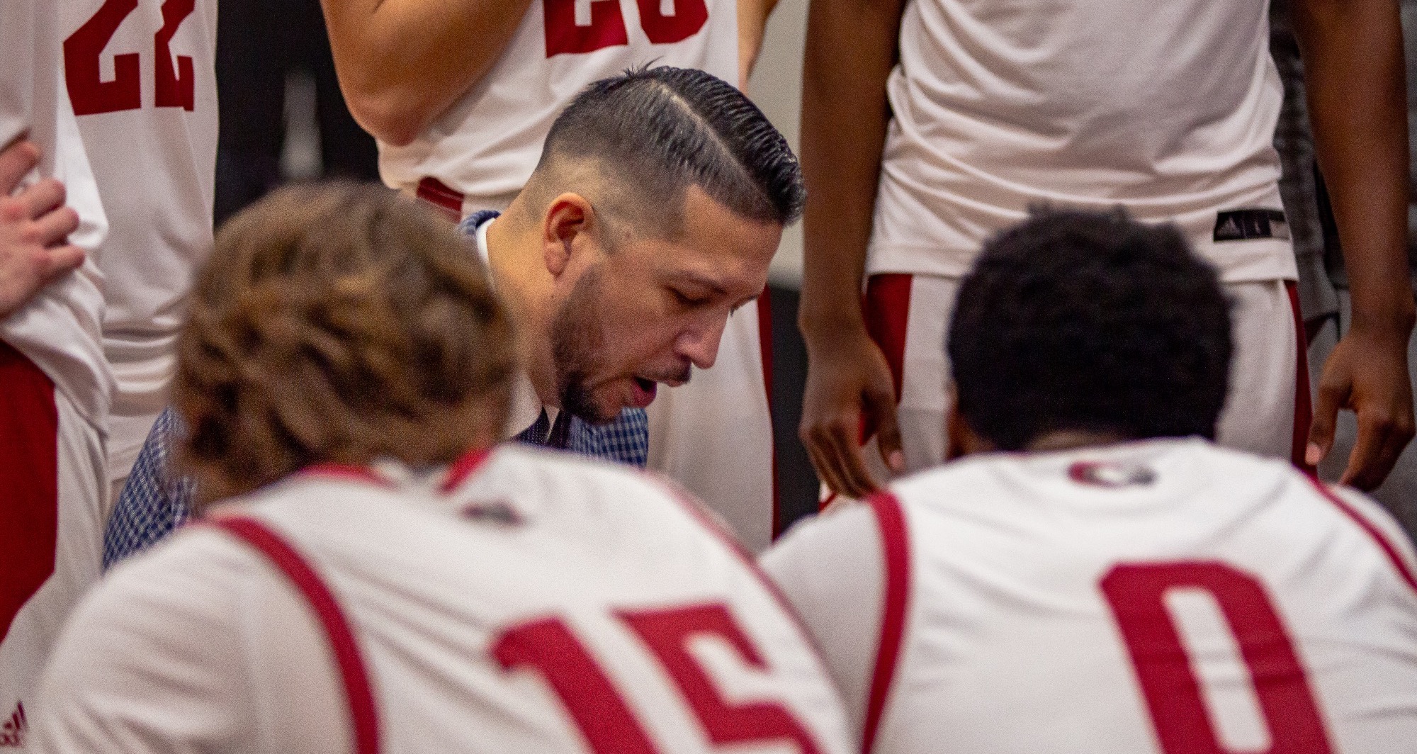 Coach Francis in the huddle talking to players