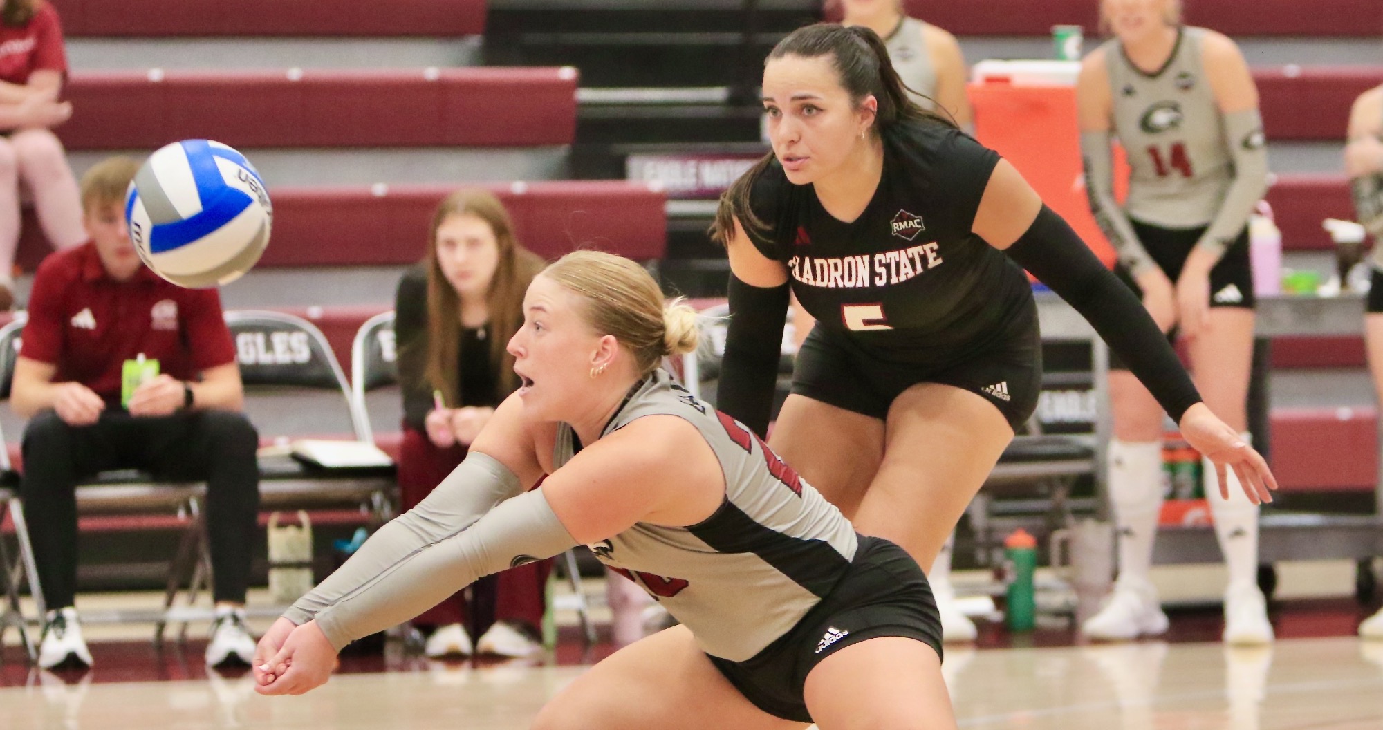 Josie Loosvelt digs as Avery Lacy looks on vs. CCU