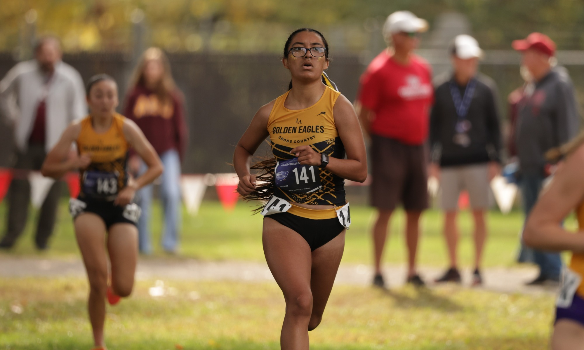 nelly garnica runs toward the finish line at ccaa championships
