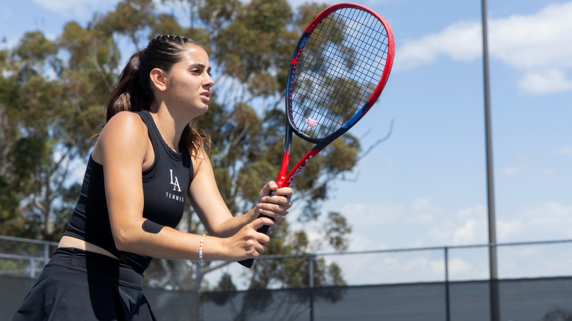 lea rolland gets ready at the net during doubles match