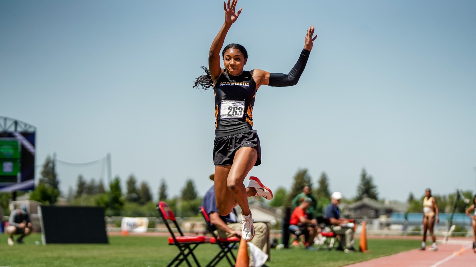 jonon young soars through the air during triple jump at ccaa championships