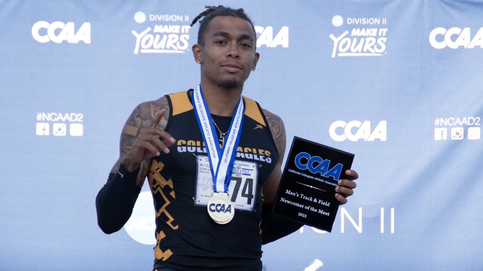 Drew Hill poses with his CCAA Newcomer of the Meet award
