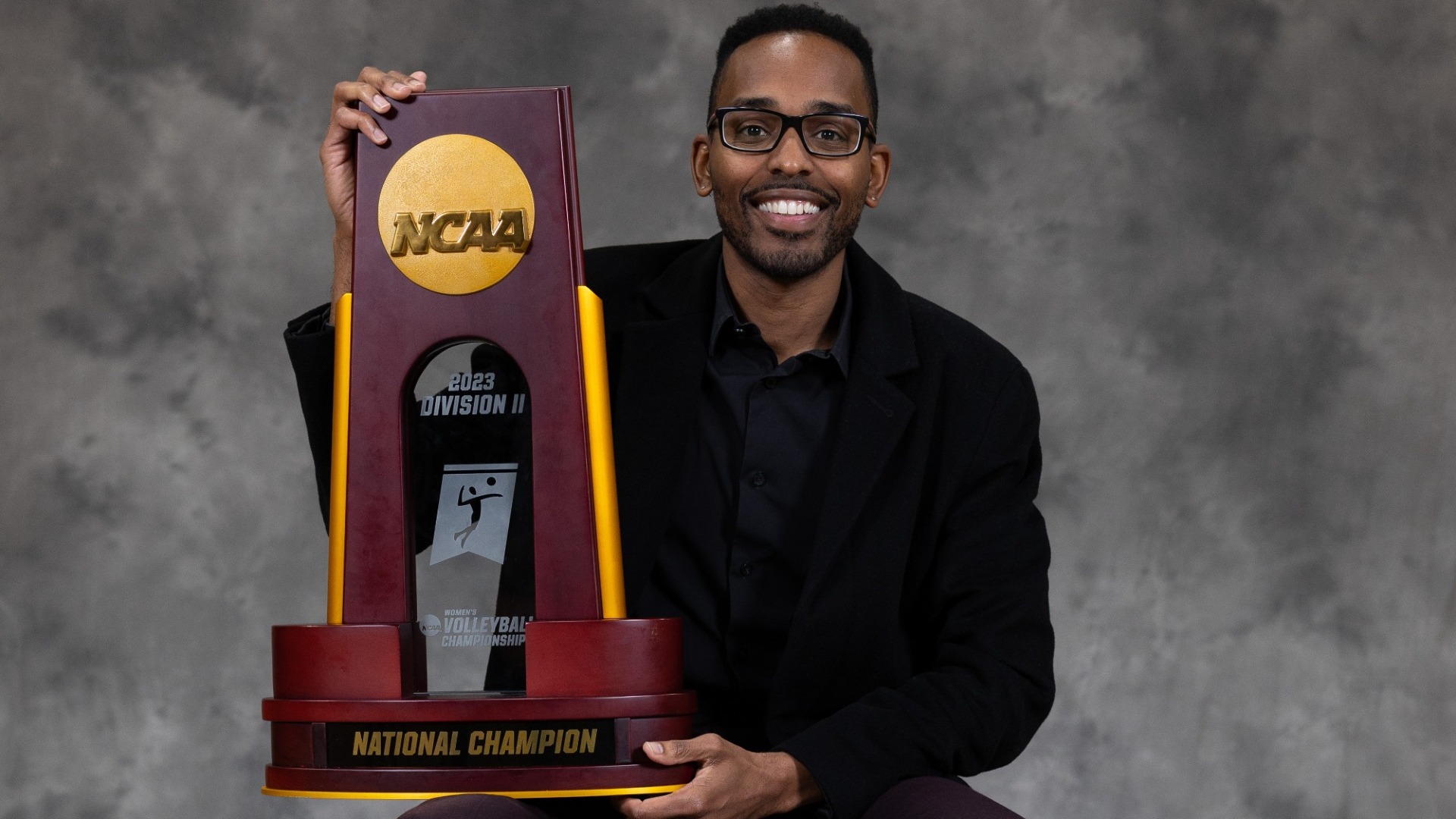 dr. demetrus caldwell with national championship trophy