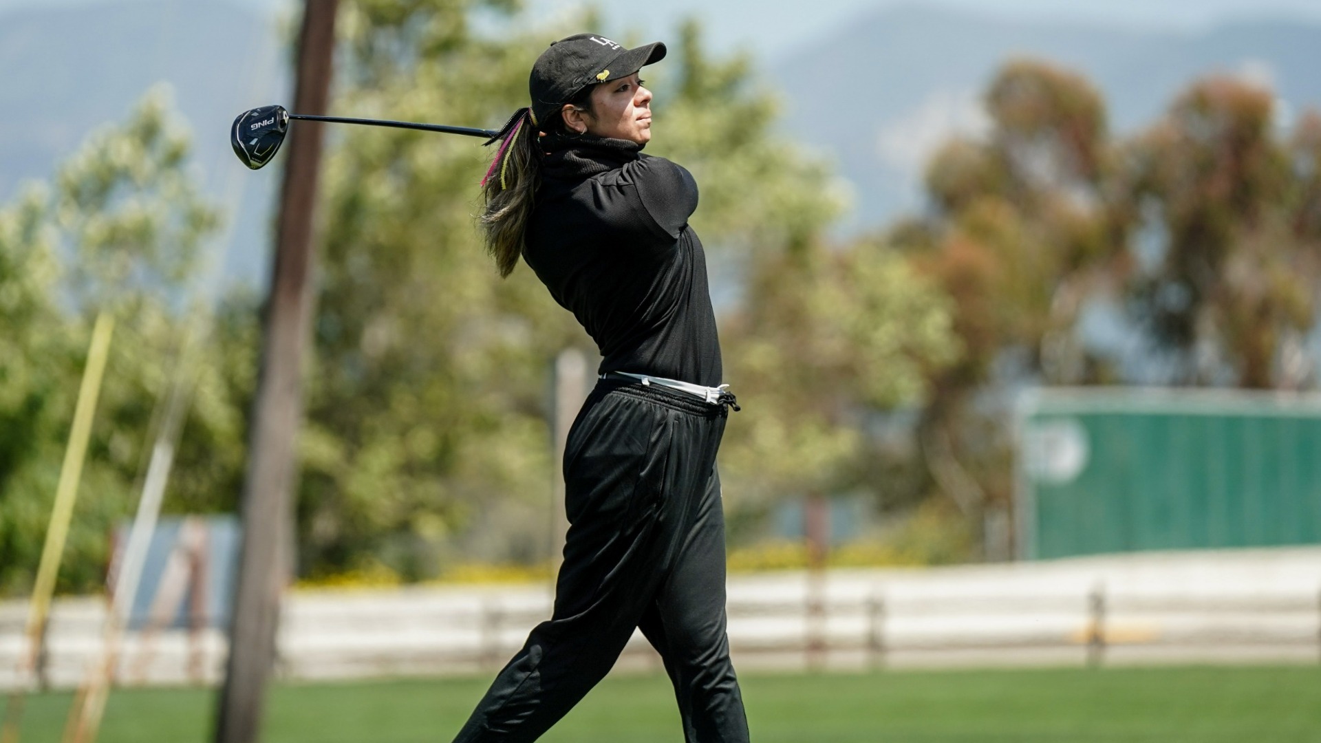 joshlyn ayala follows through on a tee shot
