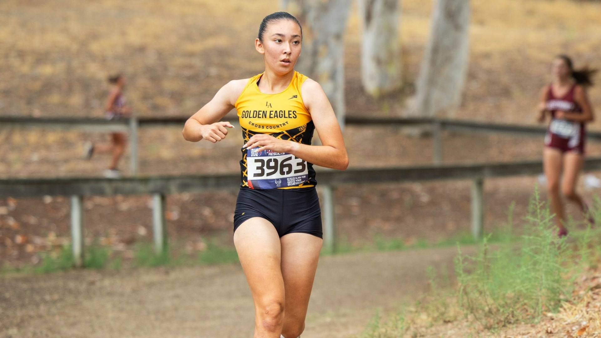 mikaela holguin rounds a corner during cross country race