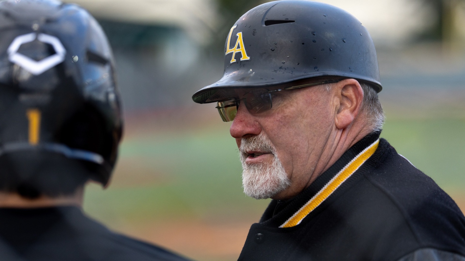 head coach vince beringhele talks to a player