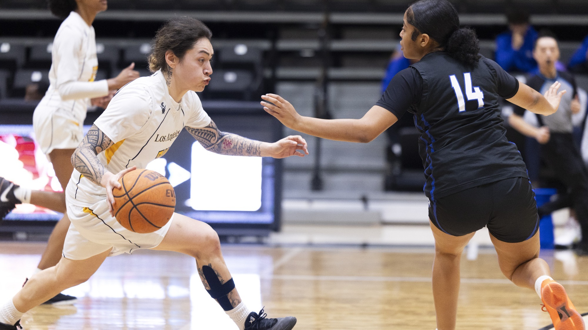 nevaeh asiasi dribbles toward a Cal State San Marcos defender